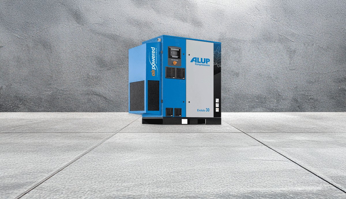 Variable-speed screw compressor operating in industrial workspace